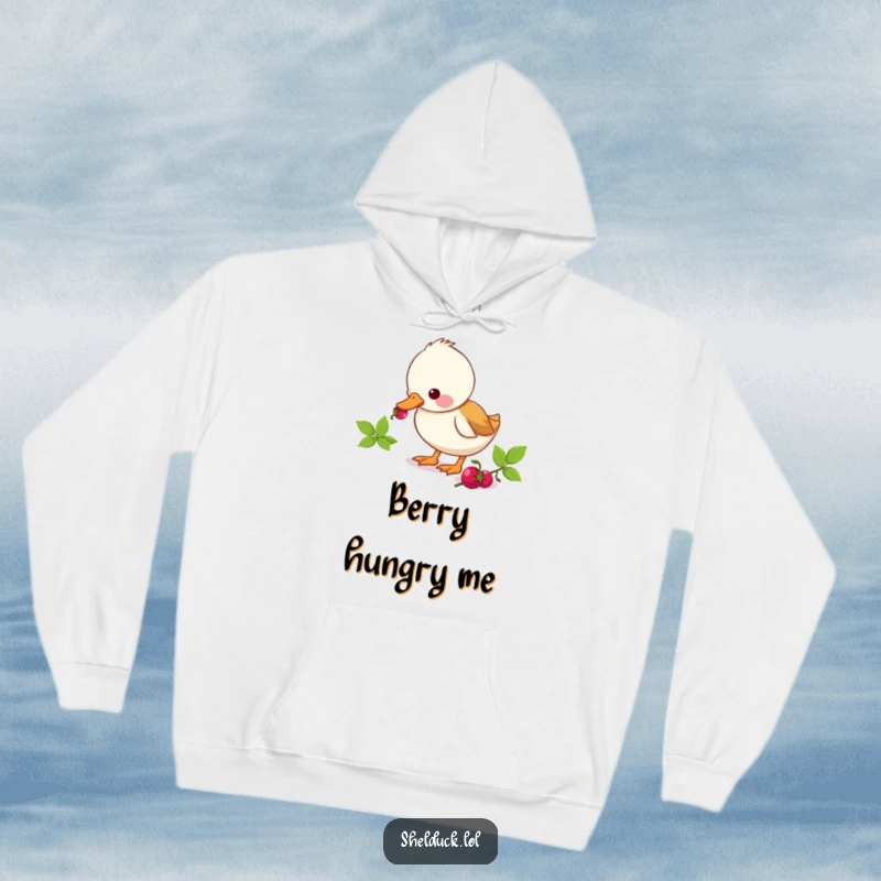 Funny shelduck hoodie showing a cute duck character enthusiastically pecking at a berry, a humorous depiction of a tasty moment.