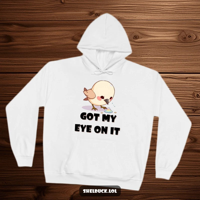 Funny bird excitedly pecking at a shiny object, featured on a warm hoodie, ideal for bird lovers.