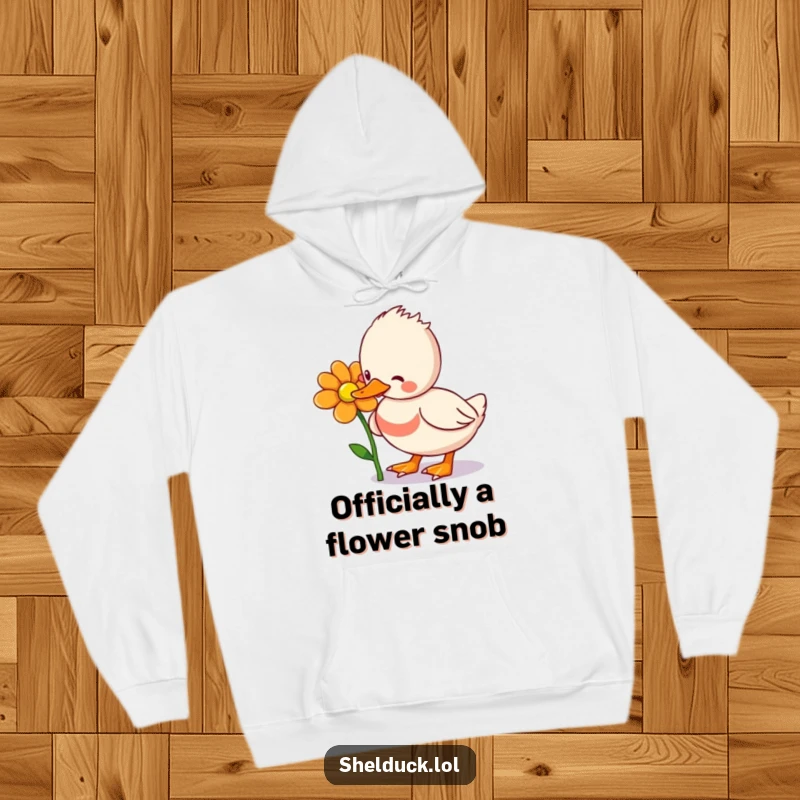 Funny Shelduck Hoodie: A charming shelduck bird in mid-peck at a blooming flower, designed for warmth and hilarious enjoyment.