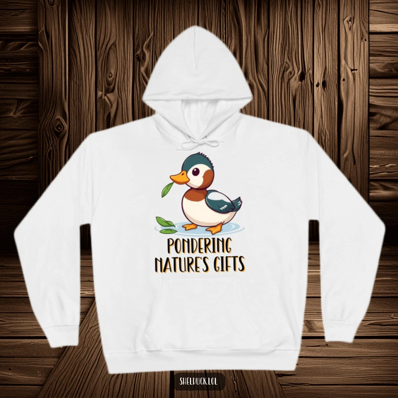 Funny Shelduck Hoodie with a shelduck tilting its head curiously at a leaf, combining comfort with lighthearted inquisitiveness.