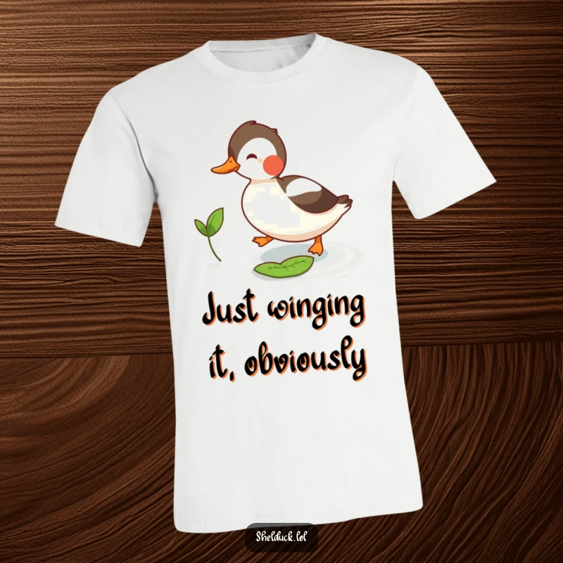 Funny shelduck t-shirt showing a determined bird playfully chasing a small leaf, a delightful scene of outdoor amusement.