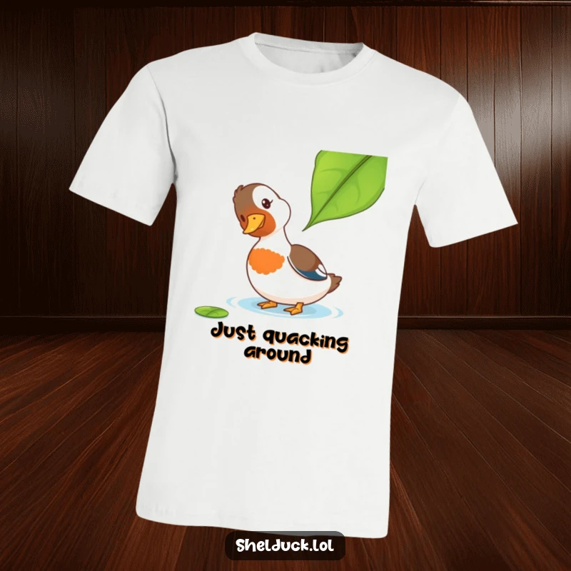 Funny Shelduck T-Shirt: A shelduck with a tilted head looks curiously at a leaf, a perfect embodiment of funny, gentle inquiry for your wardrobe.