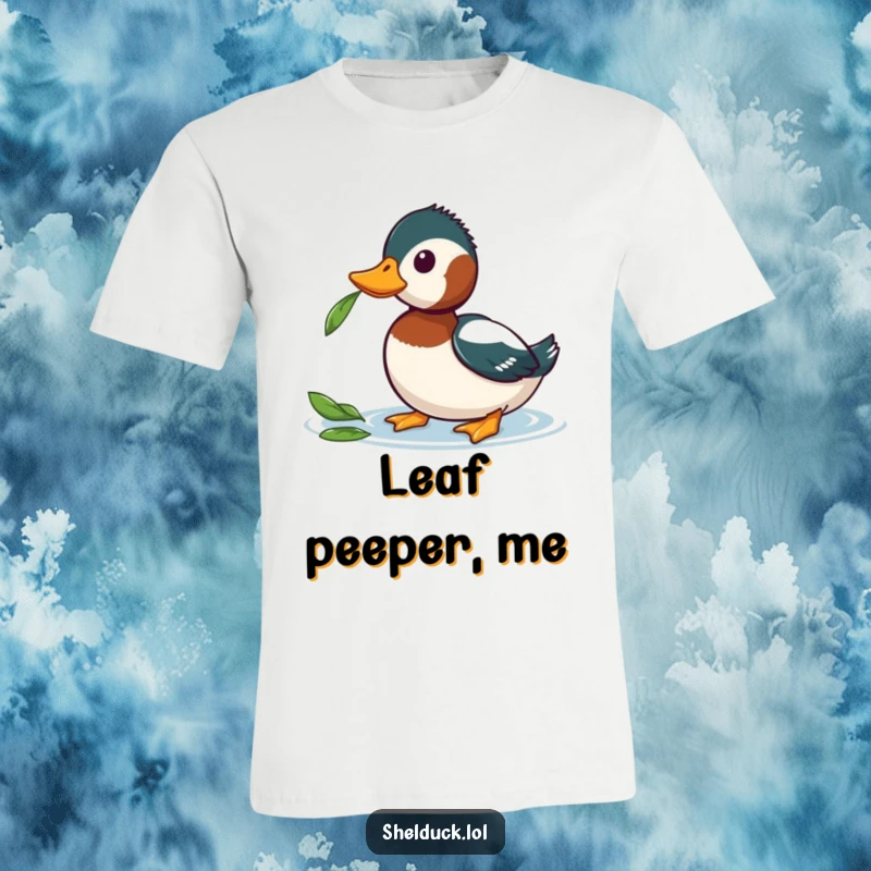 Funny Shelduck T-Shirt featuring a shelduck curiously tilting its head at a floating leaf, showcasing gentle humor and observation.