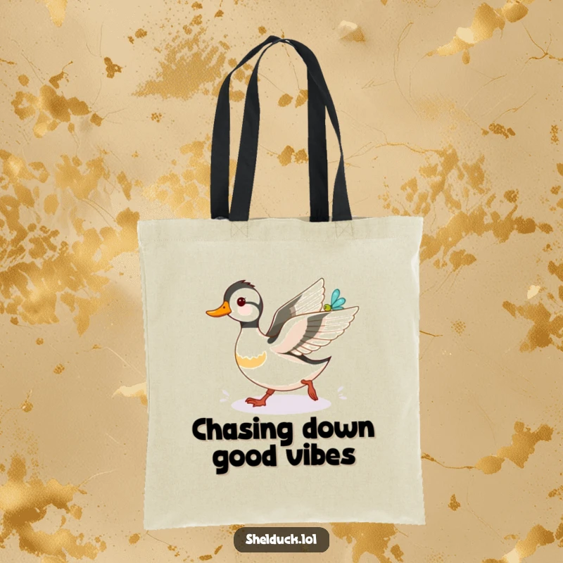 Funny shelduck tote bag, playfully stalking a luminous dragonfly, showcasing a whimsical and funny wildlife scene for everyday use.
